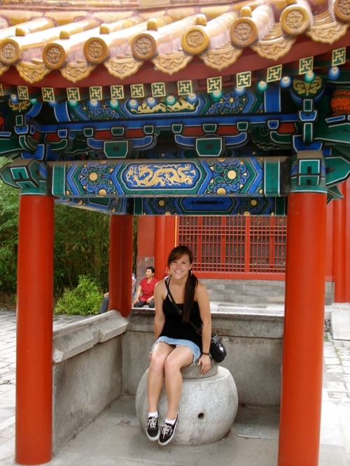 Study Abroad student sitting in ornate temple gazebo