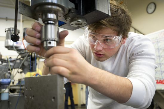 Engineering student operating machinery 