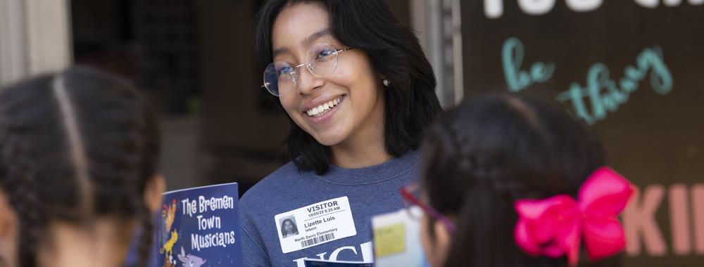 College Corps tutor reads to young students