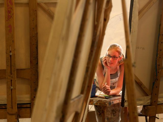 Art student in painting studio with easels