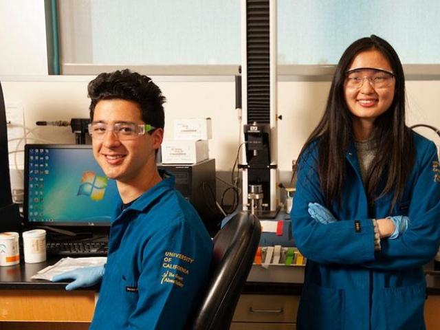 male and female student in lab gear