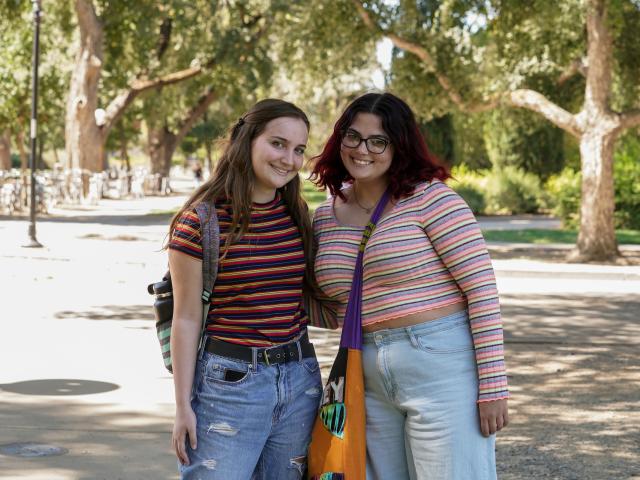 Two students in striped shirts smiling