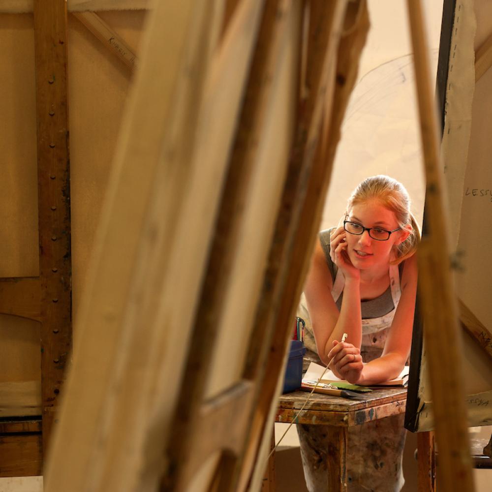 Art student in painting studio with easels