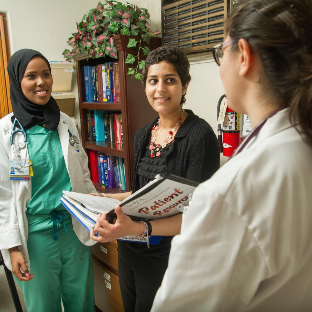 Medical students talk with professor