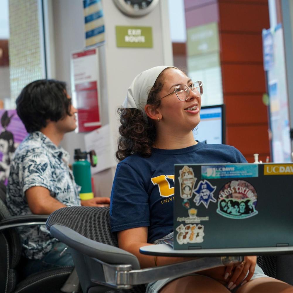 Student listening in class with laptop