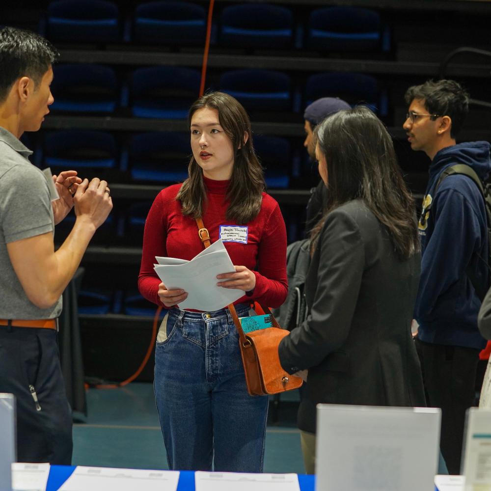 Students talk with recruiters at a career fair