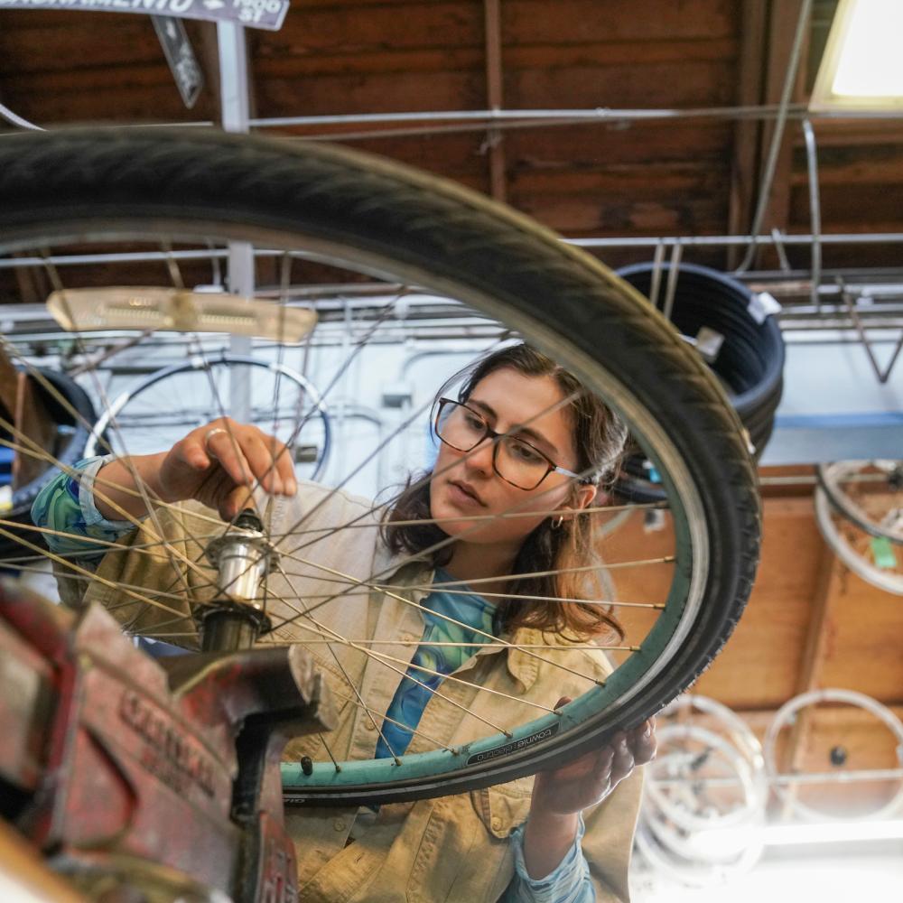 Student working on a bike in the bike barn