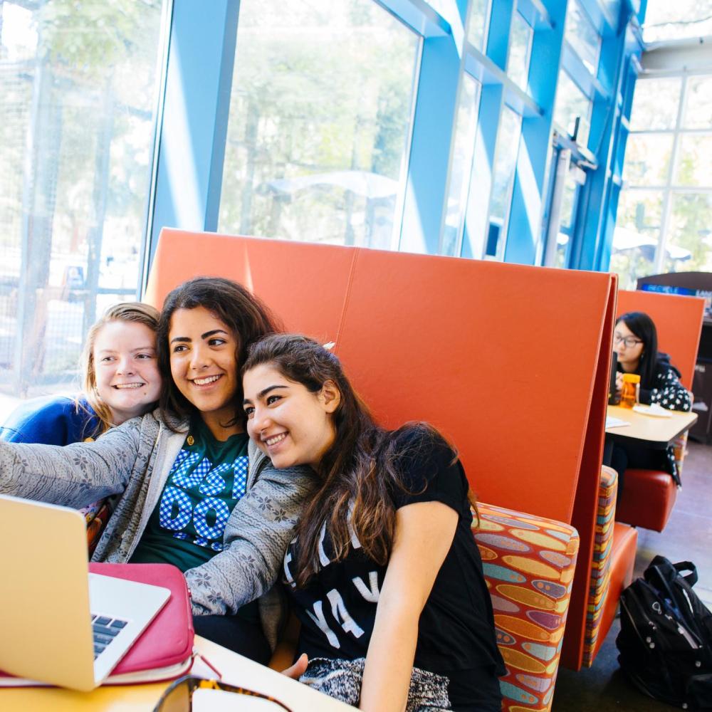Students taking group selfie in the MU