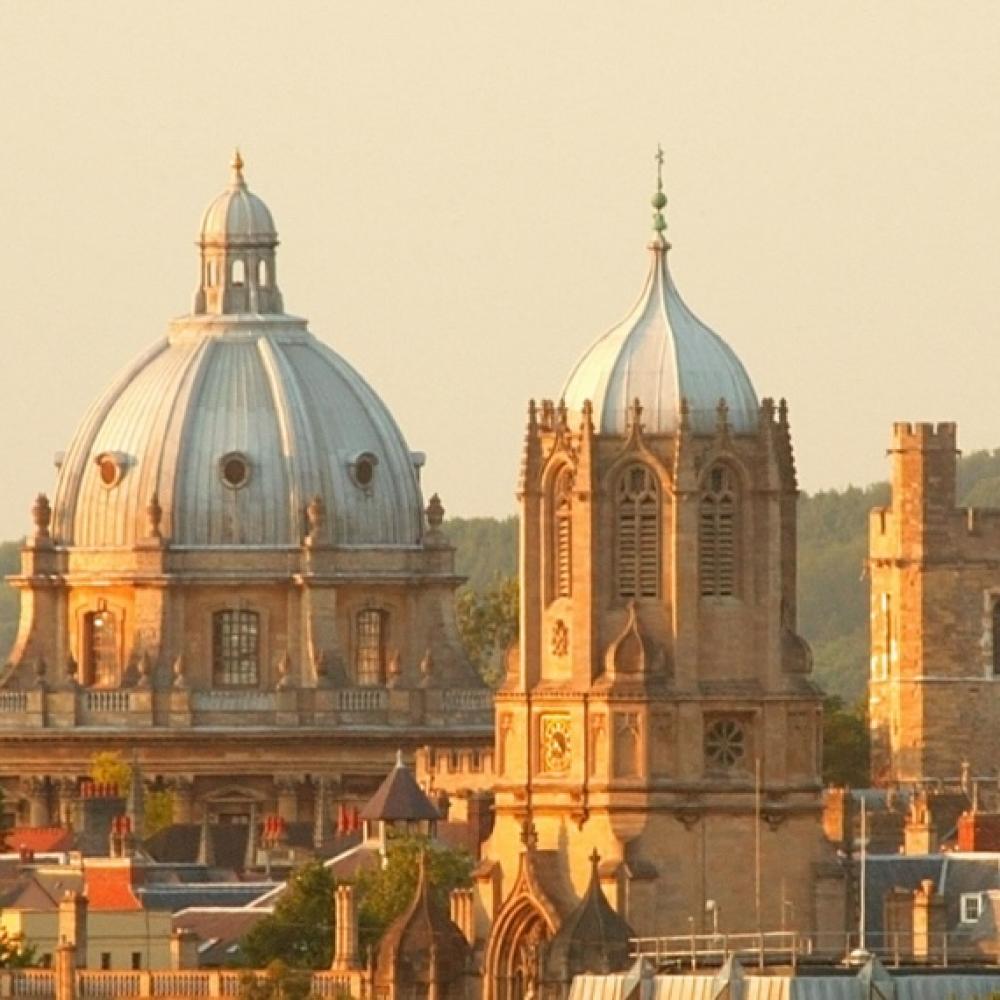 Sunlit historic city skyline with domes and spires at golden hour