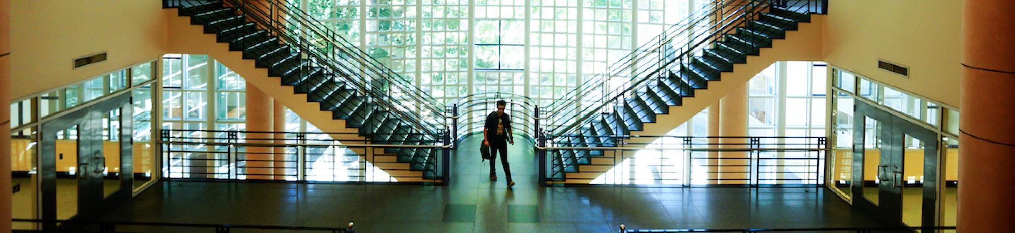 Student near stairway in Shields Library