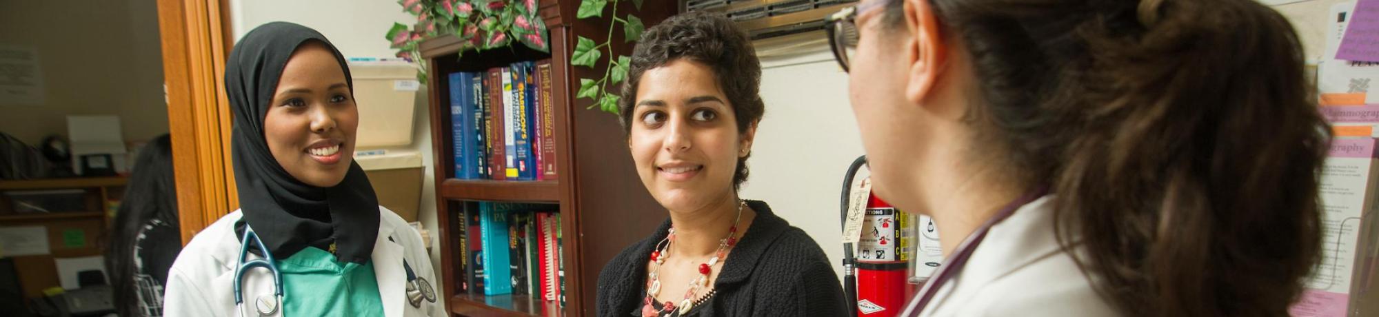 Medical students talk with professor