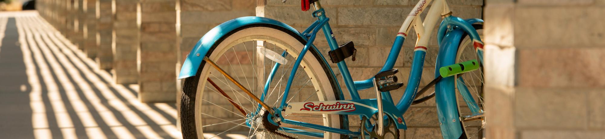 Blue bicycle in shadows near Shrem Museum
