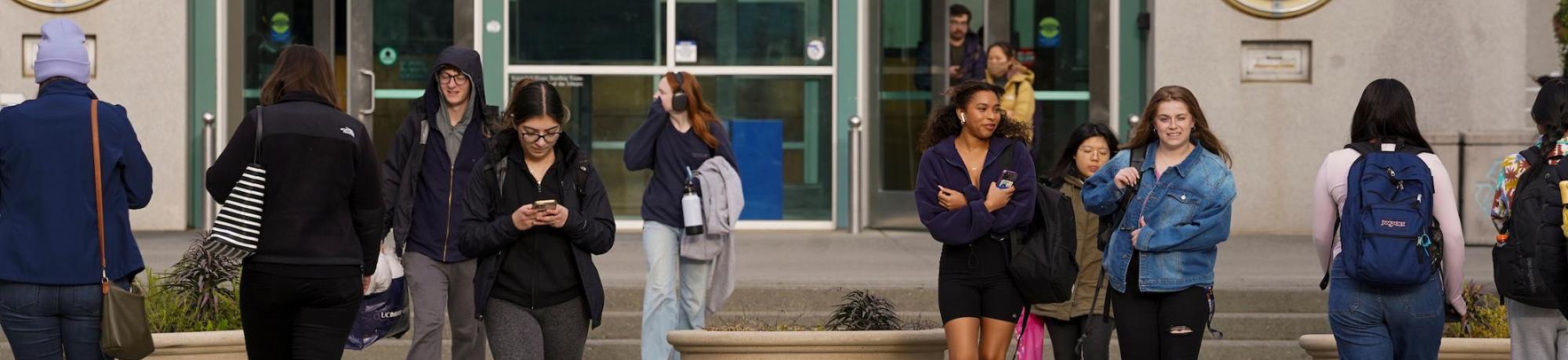 Students walking to and from the Shields Library entrance.