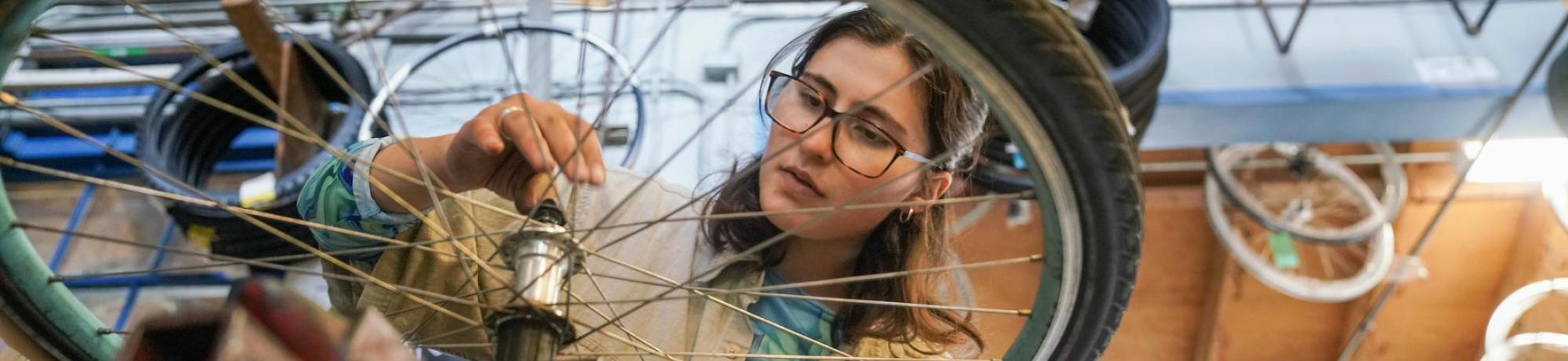 Student working on a bike in the bike barn